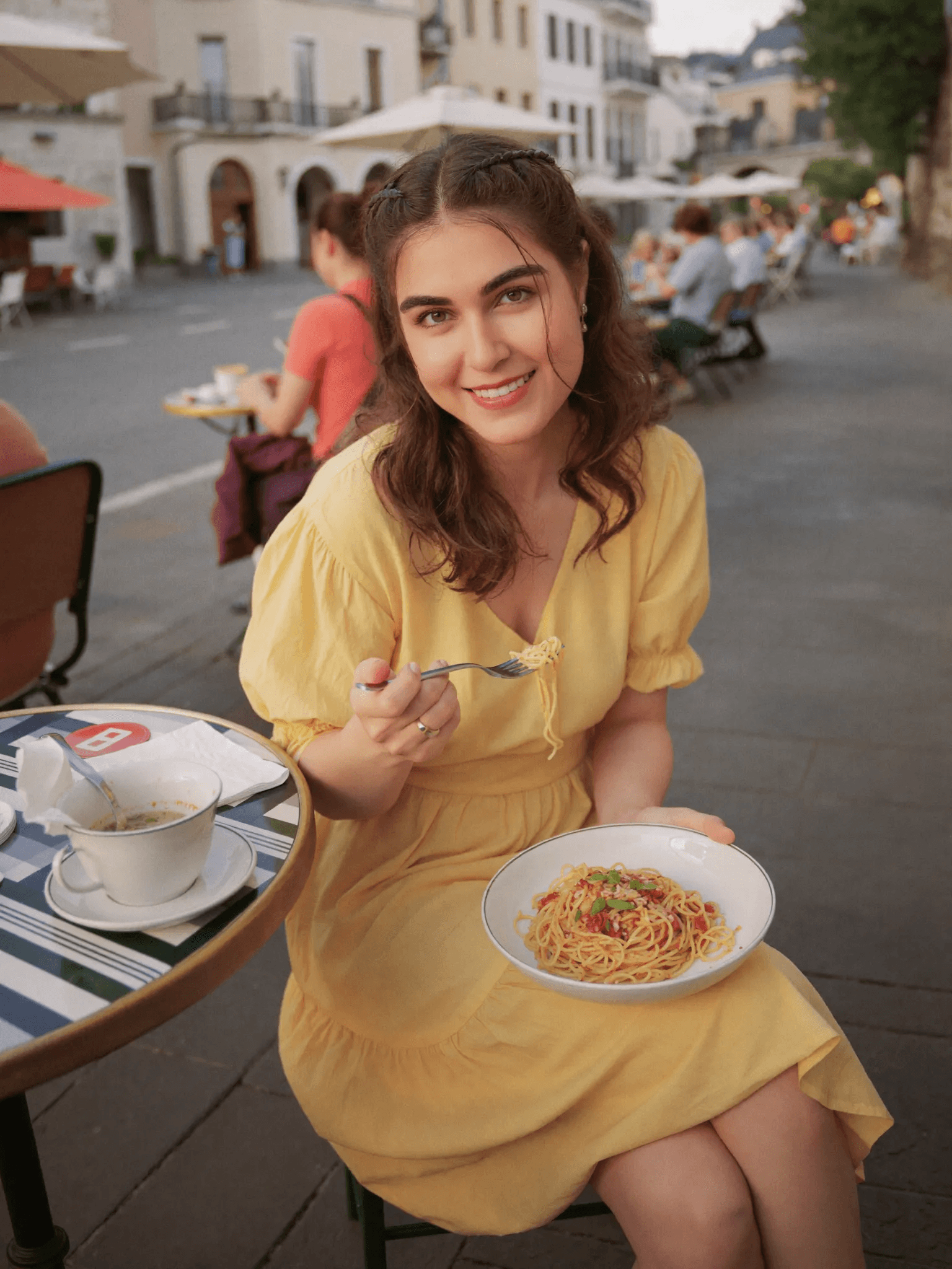 Shomaila enjoying pasta at an outdoor café